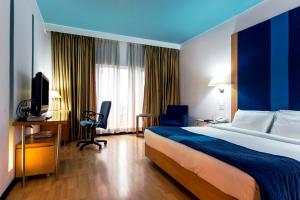 Postel nebo postele na pokoji v ubytování Hotel Royal Orchid Bangalore