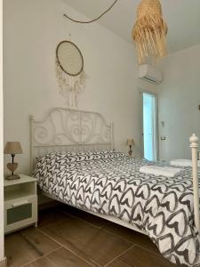 a bedroom with a bed with a black and white comforter at Paradise Lake View in Castro