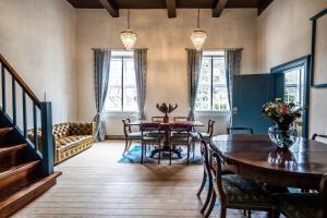 a living room with a table and a dining room at Estrup Hovedgaard in Vejen