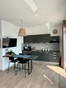 a kitchen with black cabinets and a table and chairs at Paradise Lake View in Castro