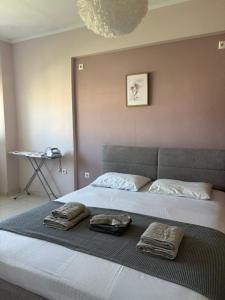 a bed with two towels sitting on top of it at La Famiglia Appartment in Perea +11 photos