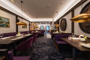 a restaurant with purple tables and purple chairs at Zur Weinsteige in Stuttgart