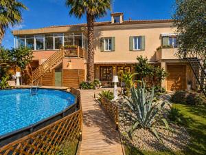 a house with a swimming pool in front of a house at Villa Irabo in Albenga