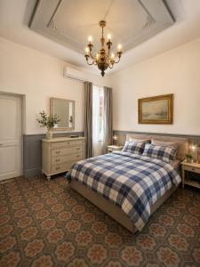 a bedroom with a bed and a chandelier at Villa Irabo in Albenga +31 photos