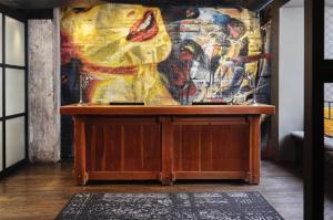 a table in a room with a painting on the wall at ACME Hotel Chicago, Outset Collection by Hilton in Chicago