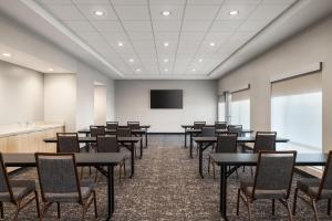 a conference room with tables and chairs and a screen at TownePlace Suites by Marriott Hickory in Hickory +26 photos
