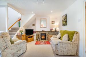 a living room with two chairs and a fireplace at 2 Bed in Middlezoy oc-s33601 in Middlezoy