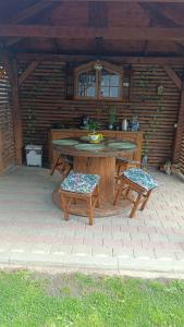 a patio with a table and chairs on a brick patio at Casa Sara in Turda