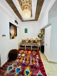 a living room with a couch and a rug at Dar 07 in Oulad Akkou