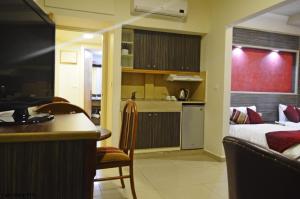 a kitchen and a bedroom with a bed and a table at Elysee Residence in Beirut +8 photos
