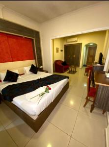 a hotel room with a bed with a flower on it at Elysee Residence in Beirut