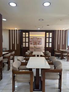 a waiting room with tables and chairs in a building at Elysee Residence in Beirut