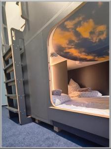 two bunk beds in a room with a painting on the ceiling at Fabcap Kapsel Apartment in Halle an der Saale