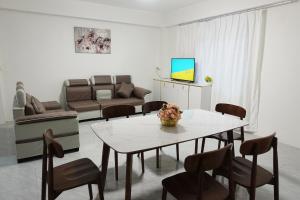 a living room with a table and a couch at Nadi Easy Home Near McDonalds in Nadi