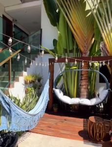 a hammock with a bunch of plants in it at Pousada Praiana in Porto De Galinhas