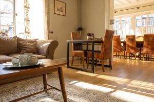 a living room with a couch and a table at B&B Dreamcottage in Knokke-Heist