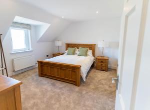a bedroom with a large bed and two night stands at 5 The Cloisters - Waterville in Waterville