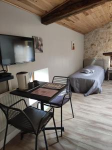 a bedroom with a bed and a desk with a table at Les Chenets in Chenay +71 photos
