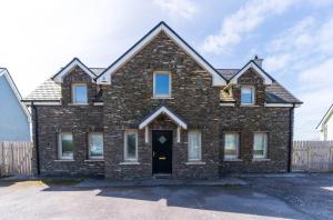 a large brick house with a black door at 5 The Cloisters - Waterville in Waterville