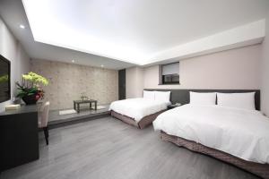 Postel nebo postele na pokoji v ubytování 宜都大飯店 Idol Hotel