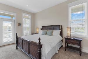a bedroom with a large bed and two windows at Sea La Vie , Walk Everywhere in Rosemary Beach +69 photos