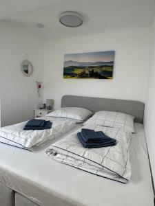 two beds in a white room with towels on them at Apartment D&A in Albbruck