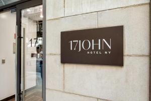 a sign on the side of a building at 17John Residences in New York