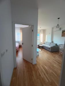 an open door to a living room with a couch at Family Home Apartment in Bar