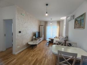 a living room with a couch and a table at Family Home Apartment in Bar