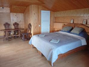 a bedroom with a large bed in a wooden room at Motel KOKOS in Kosiv