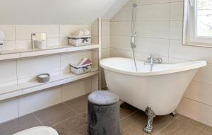 a white bathroom with a tub and a sink at Gorgeous Home In Buzim in Bužim