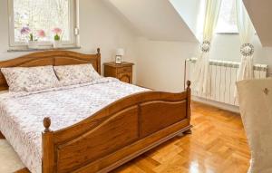a bedroom with a wooden bed with a wooden floor at Gorgeous Home In Buzim in Bužim
