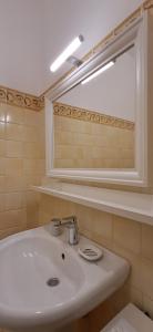 a bathroom with a white sink and a mirror at La Casa di Birba in Acquedolci +41 photos