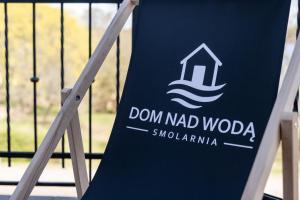 a sign that reads don nad woda on a gate at Dom Nad Wodą - Smolarnia in Smolarnia