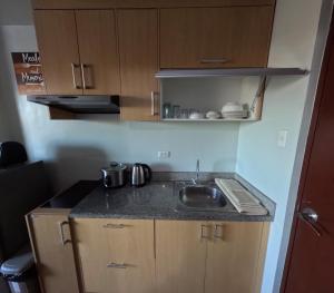 a kitchen with a sink and a counter top at Mivesa Garden Residences Lahug in Cebu City