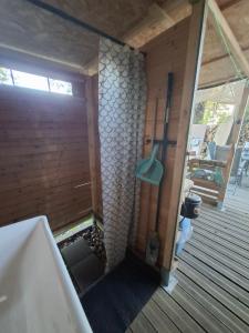 a bathroom with a bath tub and a window at Glamping Dübener Heide in Bad Schmiedeberg