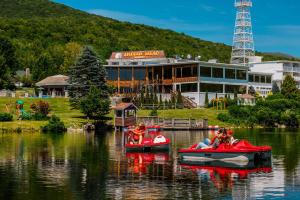 people are riding in boats on a body of water at Indian Head Resort in Lincoln