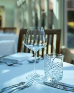 a glass of wine sitting on top of a table at Asquith Hall Hotel & Spa Scarborough in Scarborough