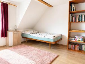 a bedroom with a bed and a book shelf at Chalupa Kukajda in Desná