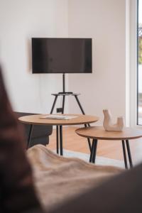 two tables in a living room with a tv at Fernruh Eifel in Dahlem