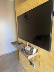 a large flat screen tv sitting on a wall at Apartamento nora in Ceuta