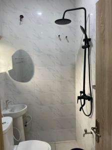 a bathroom with a shower with a toilet and a sink at Lloyd hotel in Benin City