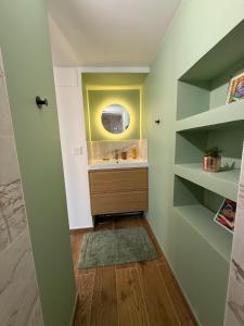 a bathroom with a sink and a mirror at Studio vert à 400 m de la plage in Le Pradet
