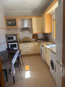 a kitchen with a sink and a stove top oven at Apartamento nora in Ceuta