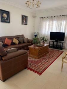 a living room with a couch and a flat screen tv at Linda's Guest House in Rotouma