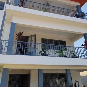 a building with a balcony with plants on it at Linda's Guest House in Rotouma +7 photos