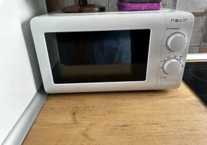 a microwave oven sitting on top of a wooden counter at Luxury art Apartamenty in Pineda de Mar