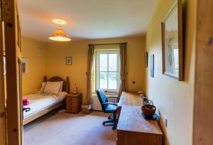 a bedroom with a bed and a desk and a desk at An Charraig in Killarney