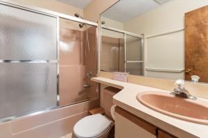 a bathroom with a sink and a shower and a toilet at Split Rock Classic Chalet – Game Room & Family Friendly in Pocono Pines +46 photos