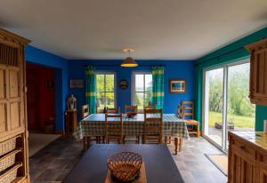 a dining room with blue walls and a table and chairs at An Charraig in Killarney